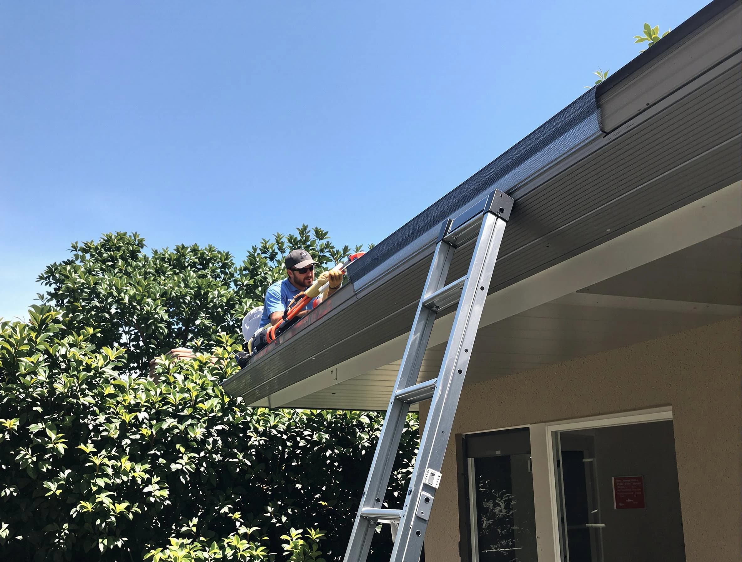 Elyria Roofing Company installing gutter guards for a homeowner in Elyria, OH